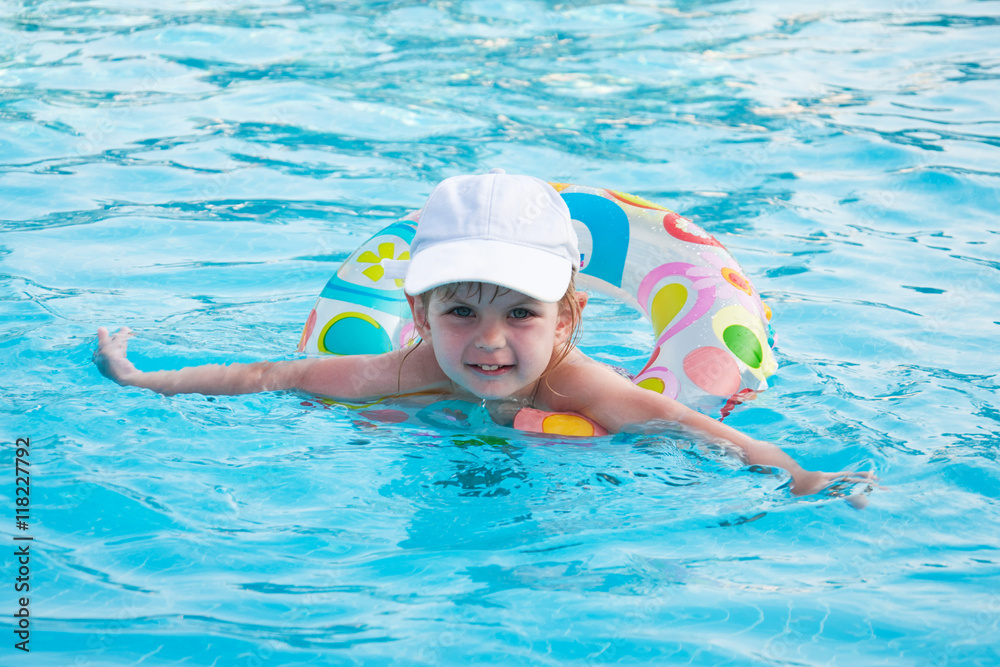 little girl swims in a pool
