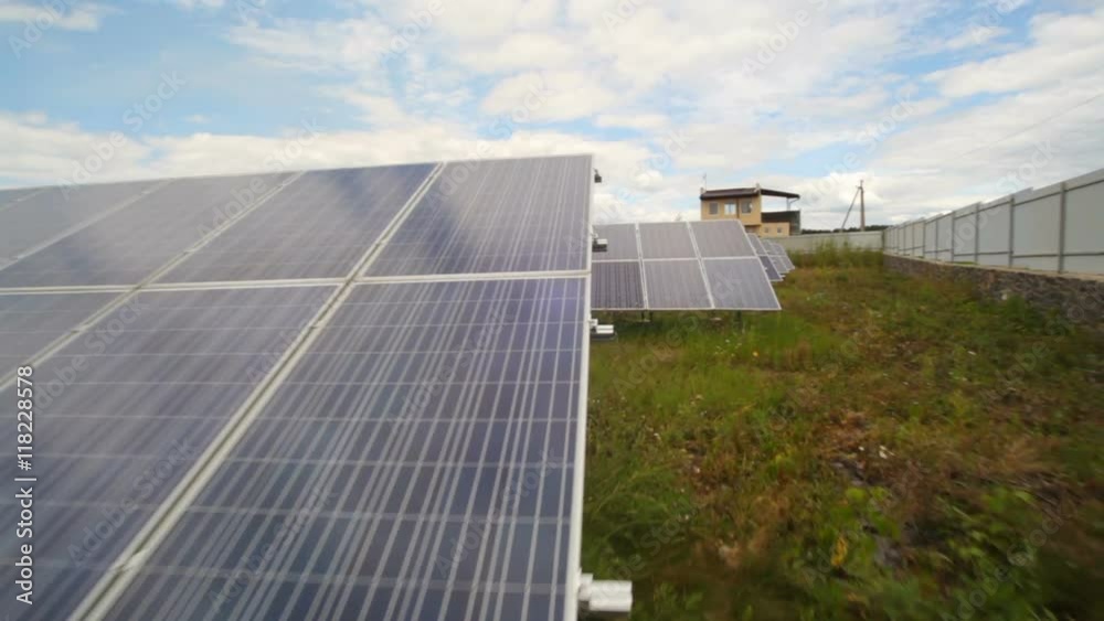 Solar panels used to generate electricity from sunlight against clouds and sky. Solar panels used to generate electricity from sunlight against clouds and sky.