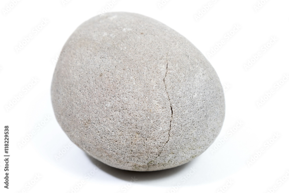 Natural stone of rounded shape on white background. Selective focus with shallow depth of field. Natural stone of rounded shape on white background. Selective focus with shallow depth of field.
