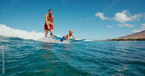 Father and son having fun surfing together, summer lifestyle family time
