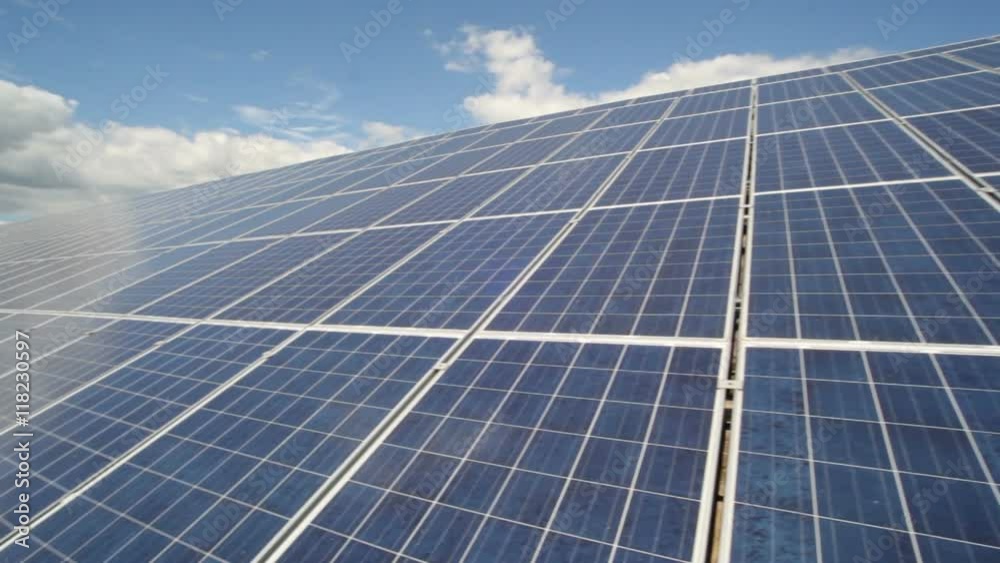 Solar panels used to generate electricity from sunlight against clouds and sky. Solar panels used to generate electricity from sunlight against clouds and sky.