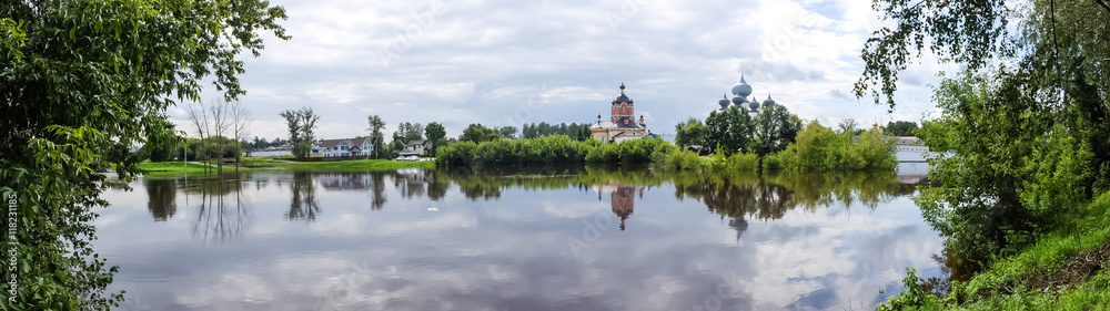 Panorama Tikhvin male monastery - it is Tikhvin icon of the mother of God. The Orthodox Church of Russia. The temple on the banks of the Tikhvinka river in Tikhvin.