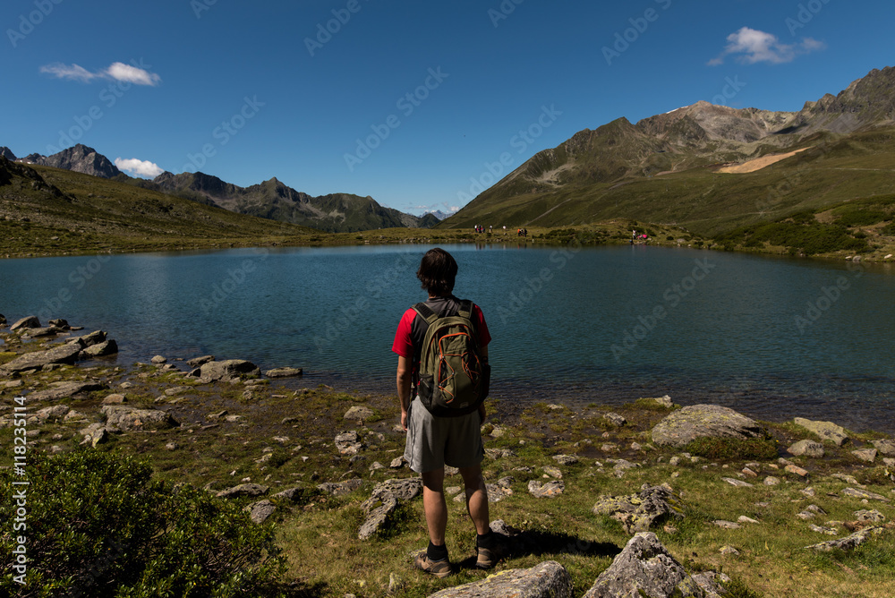Fototapeta premium Wanderer enjoys the beauty of nature in the mountains of Tyrol Austria
