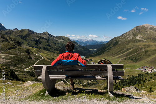 Wanderer enjoys panoramic mountain view of Kühtai Austria