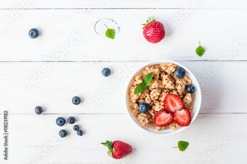 healthy breakfast with muesli and berries, top view, flat lay