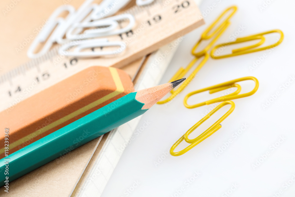 notebook, eraser, ruler, pencil and paperclips notebook, eraser, ruler, pencil and paperclips