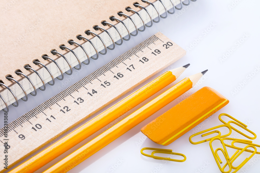 notebook, eraser, ruler, pencil and paperclips notebook, eraser, ruler, pencil and paperclips