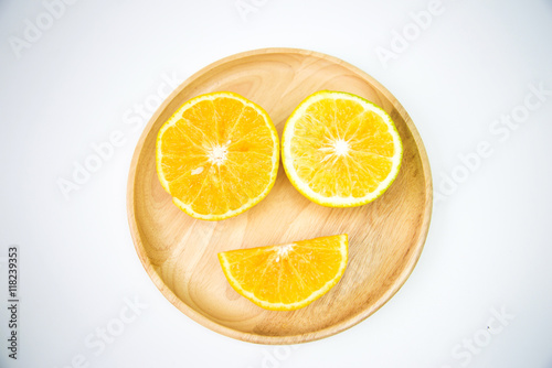 Orange put on a wooden plate To feel happy, smiling, funny.