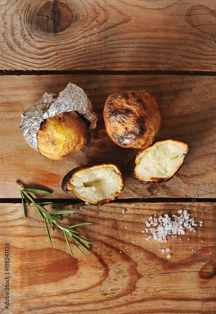 Fototapeta premium potatoes baked in foil on a wooden background