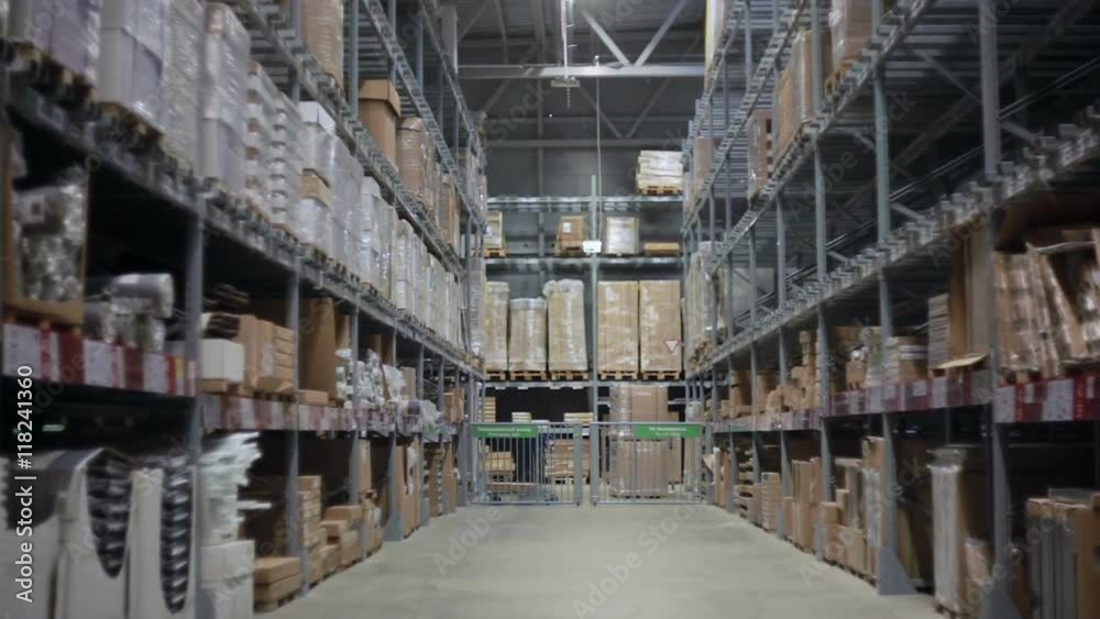 Camera moves between palettes with cardboard boxes and different materials in a storage warehouse Camera moves between palettes with cardboard boxes and different materials in a storage warehouse