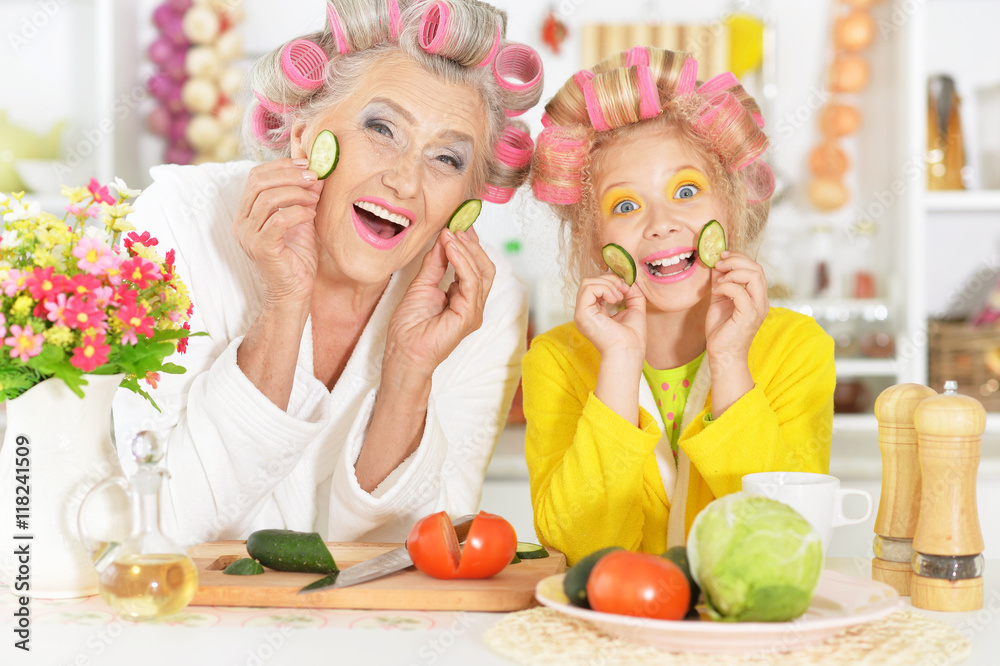 Senior woman and granddaughter at kitchen Senior woman and granddaughter at kitchen