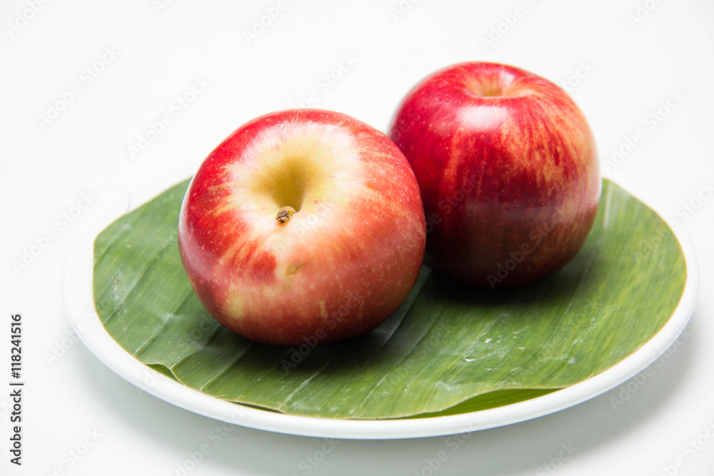 Red apple's two on with banana leaves Red apple's two on with banana leaves