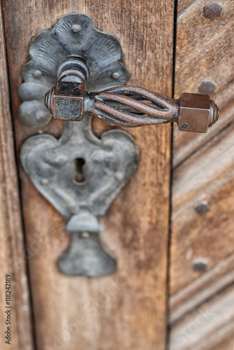 Antique door handle on an old wooden door