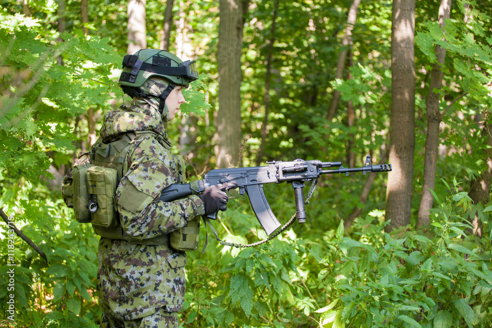 Forces soldiers in the woods with a Kalashnikov