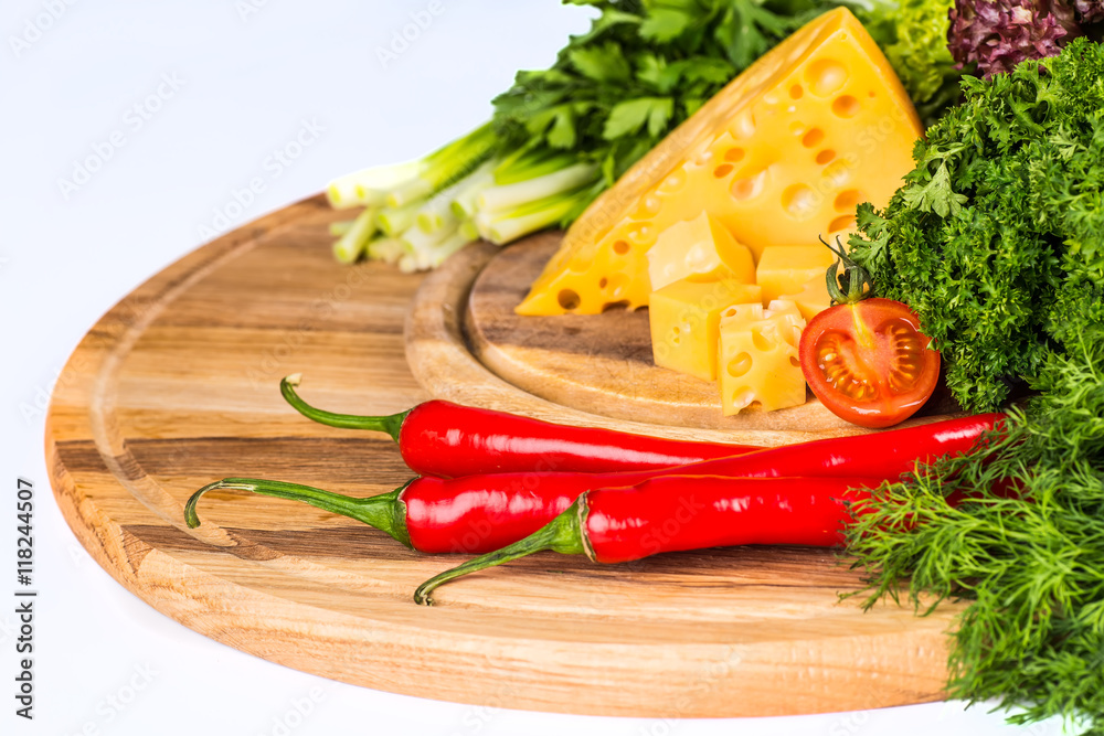 Cheese on a wooden table against the background of nature. Maasd Cheese on a wooden table against the background of nature. Maasd