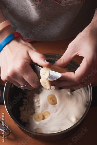 Hands of a young girl kneading the dough,