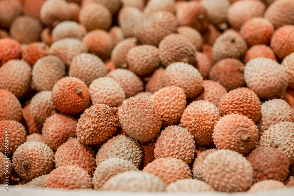 Lychee - the tropical fruit closeup in the market. fresh lychee fruits in full frame as background. Close up of freshly produced bunch of ripe Lychee fruits. selective focus Lychee - the tropical fruit closeup in the market. fresh lychee fruits in full frame as background. Close up of freshly produced bunch of ripe Lychee fruits. selective focus