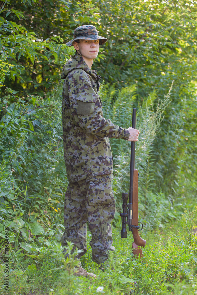 hunter in the woods with a gun