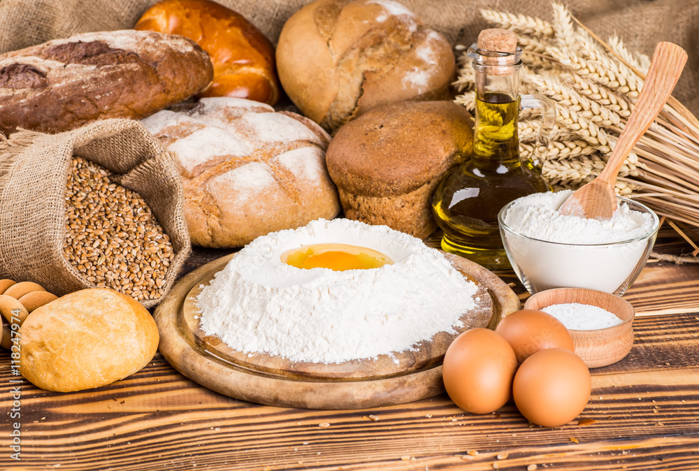 Assortment of baked bread on wooden table background Assortment of baked bread on wooden table background