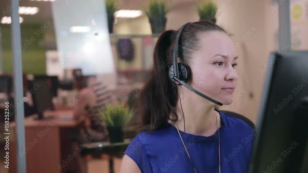 Caucasian woman at a Call center in a bright clean office. HD.
