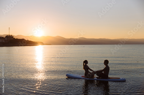 Silhouette of perfect couple engage standup paddle boarding