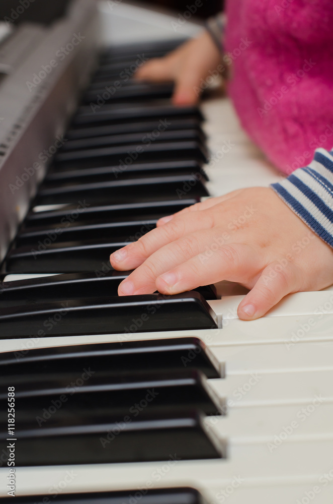 child plays the piano