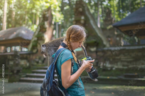 tourist in Indonesian temple do pictures of monkey on camera