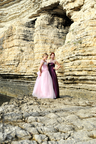 young fashion girls posing on the rocks with fashion dress © murattellioglu
