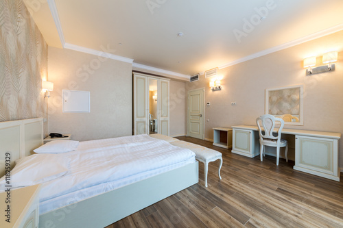 Interior of a hotel room with beds table and wardrobe in El Paraiso hotel