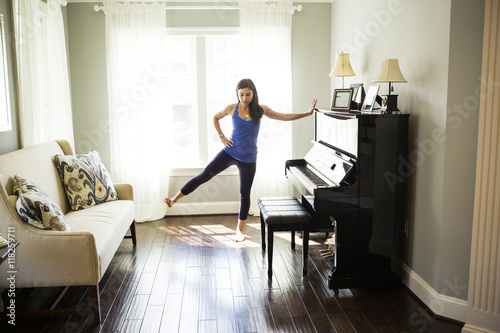 Woman stretching at window photo