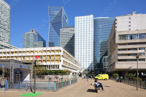 Street with pedestrians and the skyline of the business district La Defense in Paris