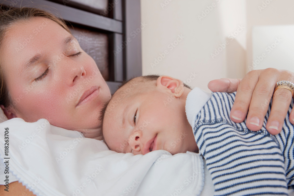 Baby boy sleeping on mothers chest Baby boy sleeping on mothers chest