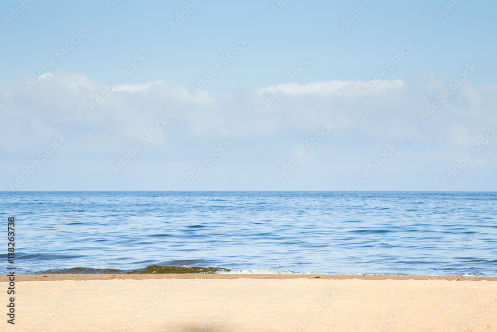 Sunny morning on empty sandy beach in summer