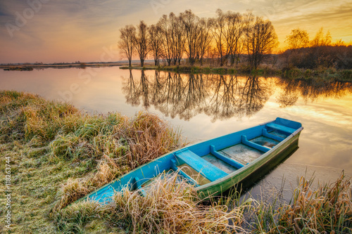 Lake, River And Old Wooden Blue Rowing Fishing Boat At Beautiful Sunrise