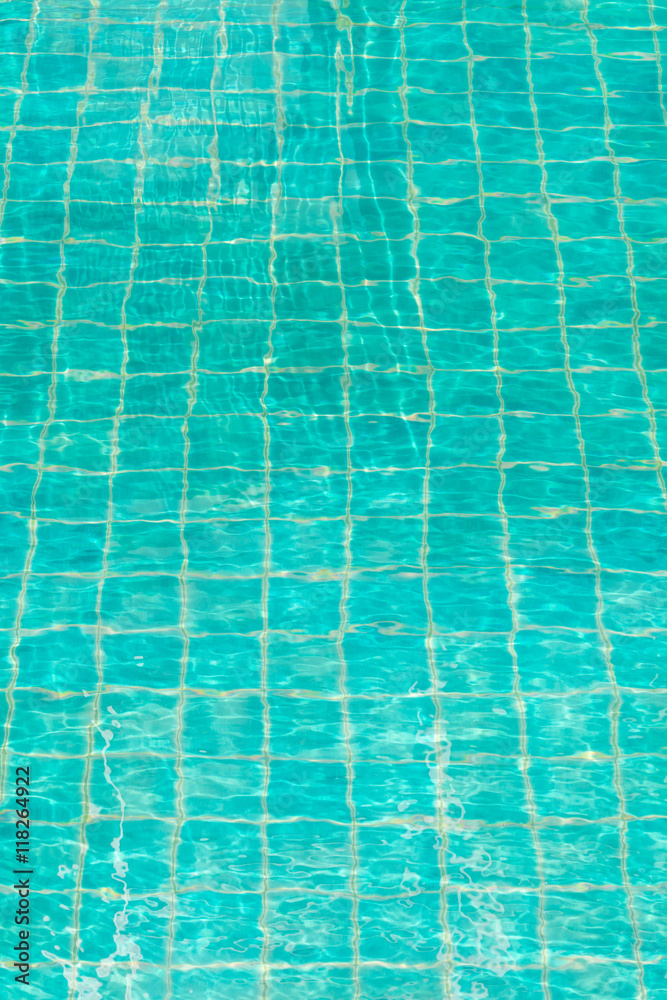 Blue-green swimming pool bottom with water wave texture