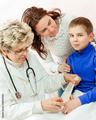 Doctor examining a child in a hospital photo