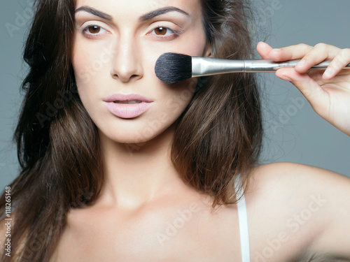 pretty woman with makeup brush