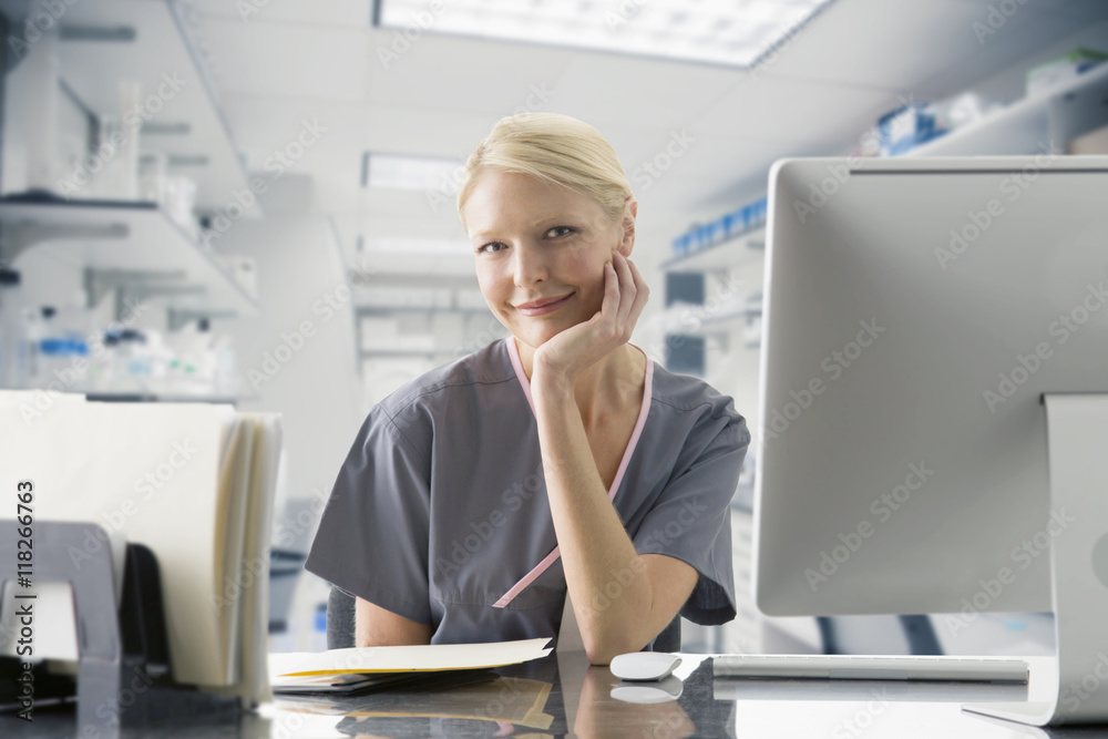 Caucasian nurse working at computer in hospital Caucasian nurse working at computer in hospital