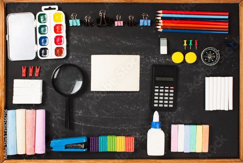 Stationery on a black background with space for text.