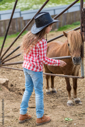 cowboy girl with a pony foal