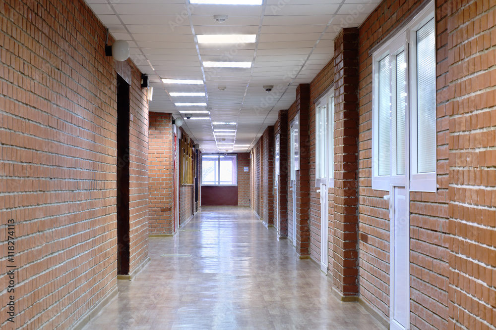 Interior of a long room with masonry and plastic windows