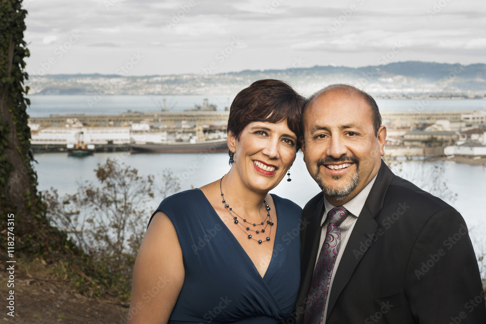 Hispanic couple hugging in formal wear Hispanic couple hugging in formal wear