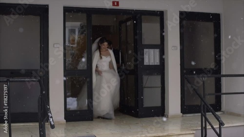 Bride and Groom going to their wedding cerenomy - Snowy weather - Slow Motion photo