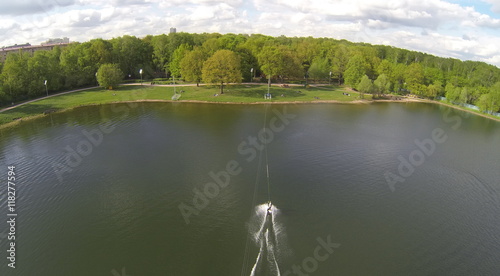 Man rides on Putyaevskii pond in city park. Aerial view. photo