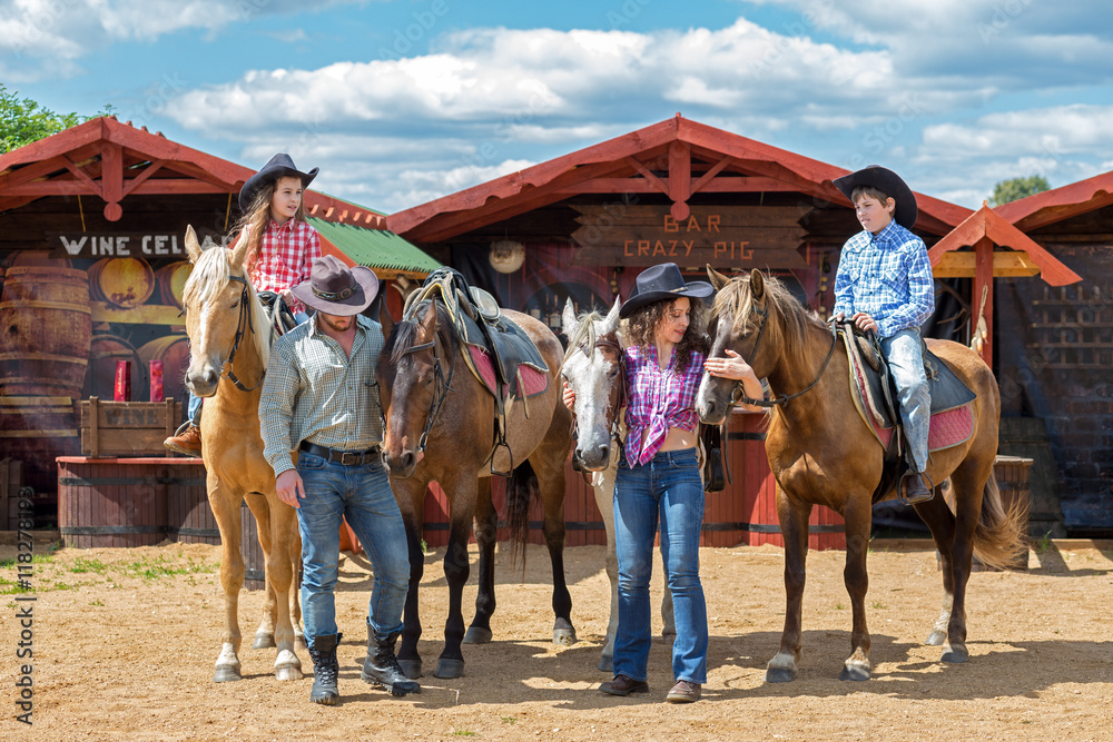 cowboy family of four with horses cowboy family of four with horses
