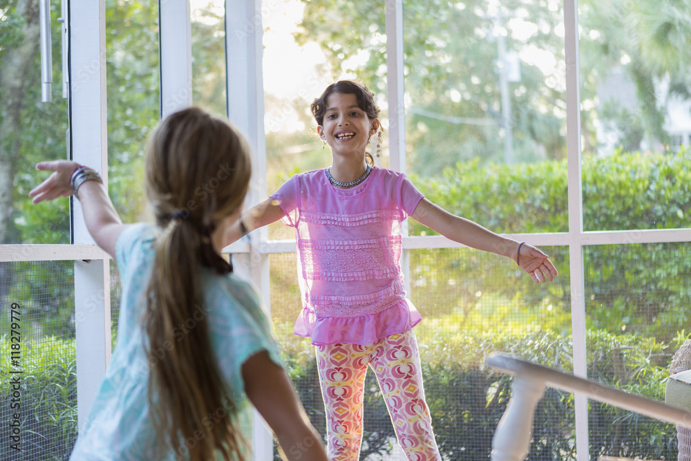 Girls playing together on porch Girls playing together on porch