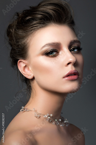 Portrait of young beautiful woman with bridal makeup and coiffur
