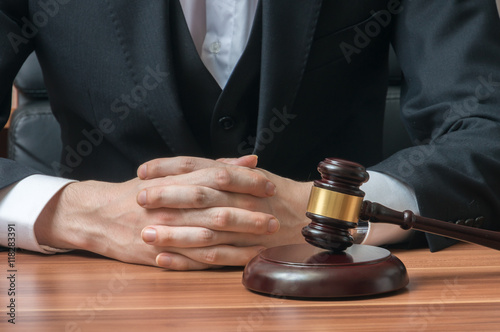 Law and justice concept. Judge or magistrate has clapsed hands.