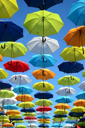 Colorful umbrellas background. Colorful umbrellas in the sunny sky. Street decoration.