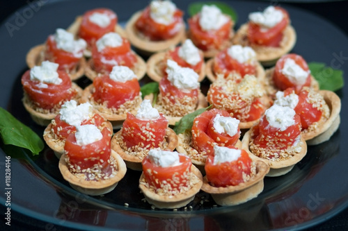 Salmon rolls stuffed with cheese sprinkled sesame seeds